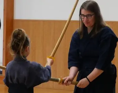 Prtaiquants de kendo en action avec un sabre en bois